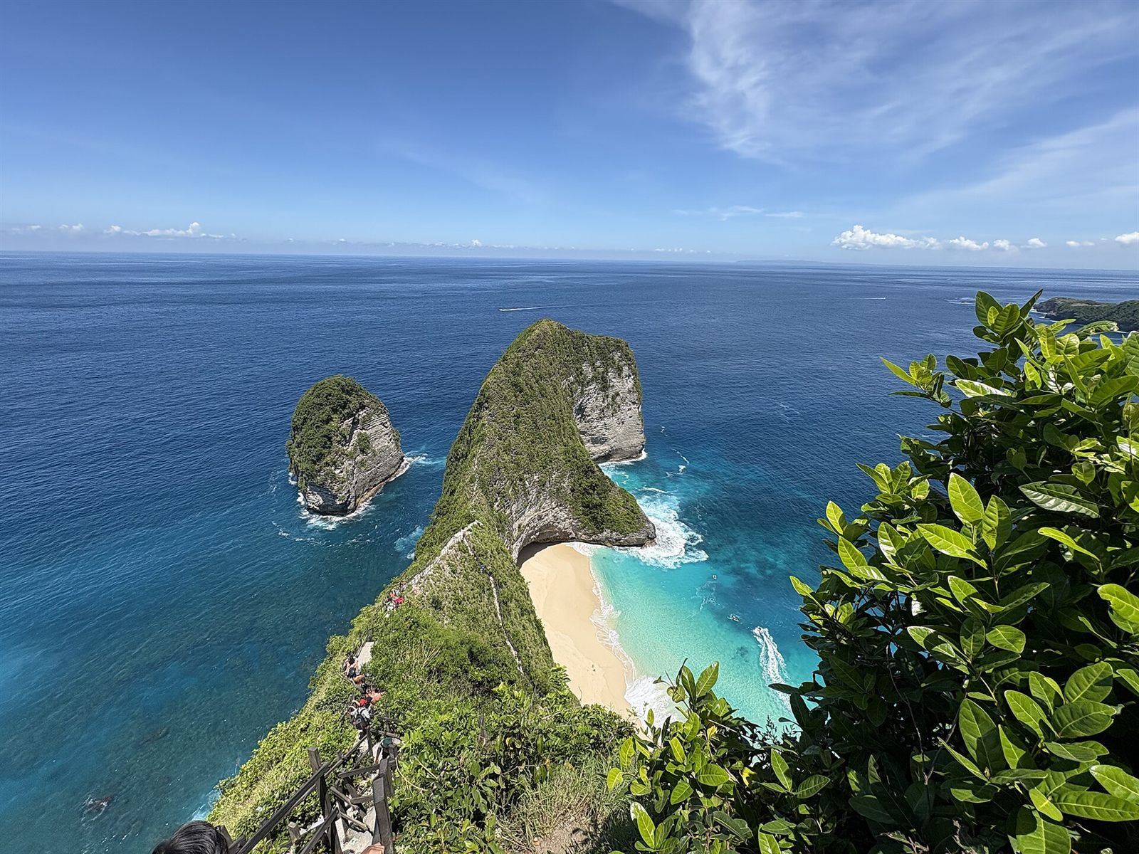 Turquoise bay framed by cliffs and jungle in Nusa Penida, Bali
