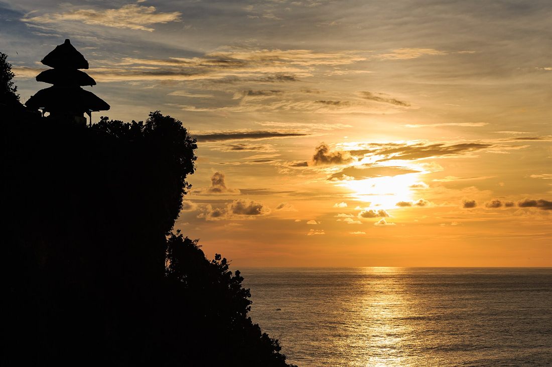Sunset over the ocean seen from Uluwatu temple, Bali