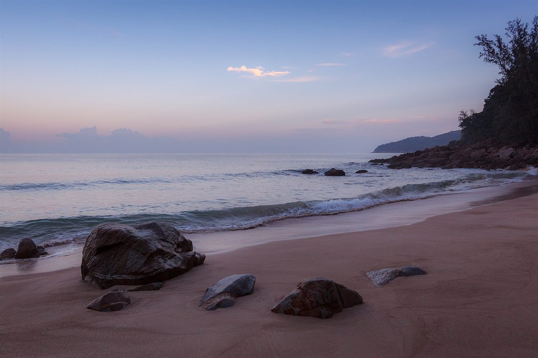 Quiet sandy beach at dusk in Phuket, Thailand